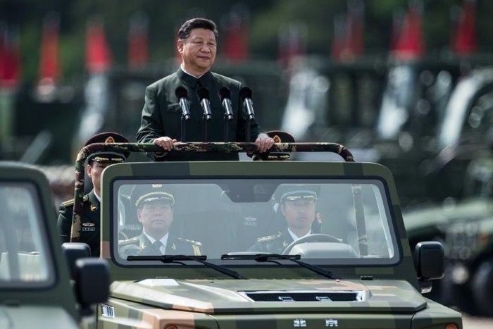 China's President Xi Jinping wore a Mao suit as he was driven in an open-top jeep past serried ranks of the People's Liberation Army, in a rare show of force in Hong Kong