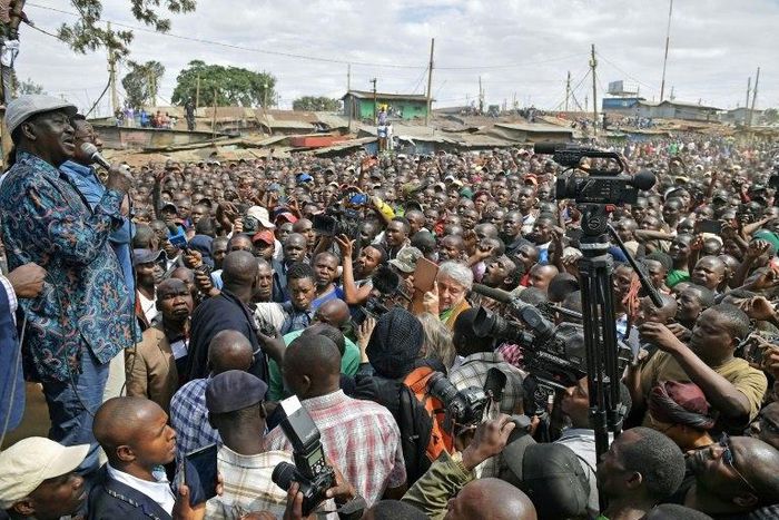 Kenya's opposition leader Raila Odinga (L) speaks in the Kibera district of Nairobi on August 13, 2017