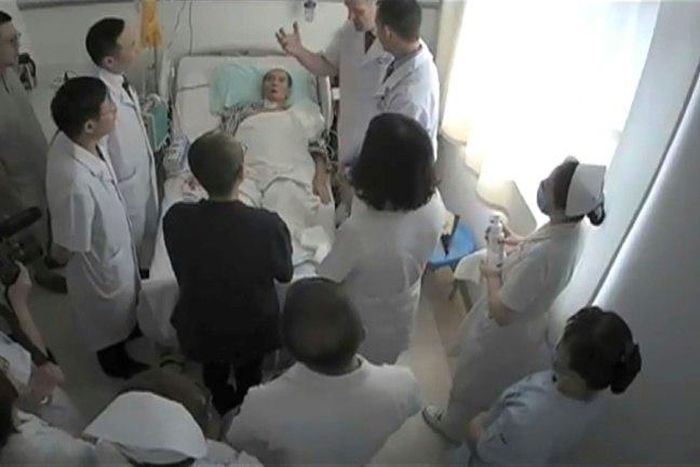 This undated video grab obtained July 11, 2017 shows Chinese Nobel Laureate Liu Xiaobo surrounded by doctors and his wife Liu Xia at an undisclosed location. The US government has expressed concern about the cancer-stricken democracy activist