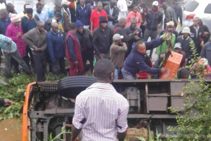 The matatu in the ditch with passengers stuck inside