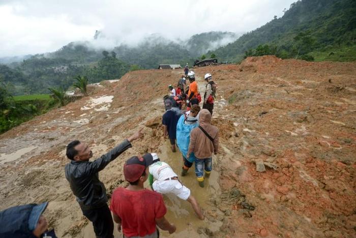 Rescue workers search for survivors at the site of a landslide triggered by heavy rain, in Sukabumi, Indonesia's West Java province, on January 1, 2019