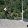 A police officer stands guard at a roadblock near the small Catalan town of Ripoll as part of a manhunt for suspects in the Barcelona and Cambrils attacks