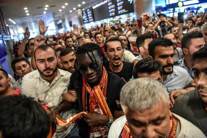 French forward Bafetimbi Gomis (C) is greeted by fans as he arrives at the Ataturk International airport on June 28, 2017 in Istanbul