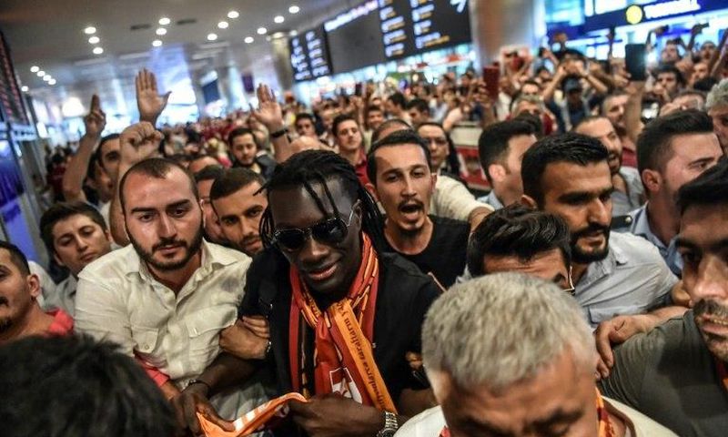 French forward Bafetimbi Gomis (C) is greeted by fans as he arrives at the Ataturk International airport on June 28, 2017 in Istanbul