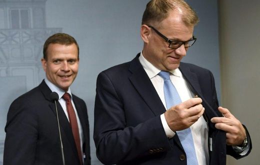 Finnish Minister of Finance, National Coalition chairman Petteri Orpo (L) and Finnish Prime Minister, Centre Party chairman Juha Sipila leave after addressing a press conference at the Prime Minister's official residence on June 12, 2017