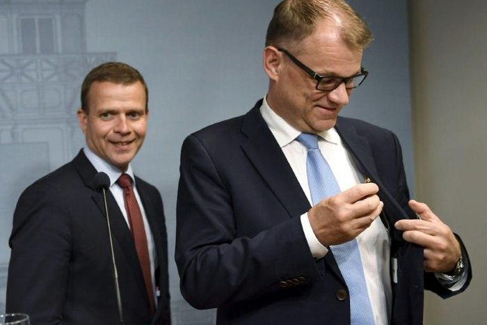 Finnish Minister of Finance, National Coalition chairman Petteri Orpo (L) and Finnish Prime Minister, Centre Party chairman Juha Sipila leave after addressing a press conference at the Prime Minister's official residence on June 12, 2017