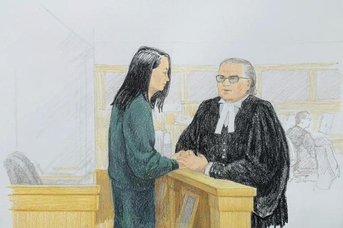 In this courtroom sketch by Jane Wolsak and released to AFP by the artist, Meng Wanzhou (L), Huawei's chief financial officer, speaks with lawyer David Martin in the courtroom in Vancouver, British Columbia on December 10, 2018