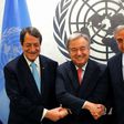 United Nations Secretary-General Antonio Guterres shakes hands with Greek Cypriot leader Nicos Anastasiades (L) and Turkish Cypriot leader Mustafa Akinci (R)