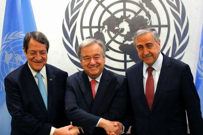 United Nations Secretary-General Antonio Guterres shakes hands with Greek Cypriot leader Nicos Anastasiades (L) and Turkish Cypriot leader Mustafa Akinci (R)