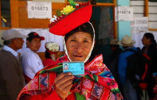 A voter in Ollantaytambo, near the ancient imperial Inca capital of Cuzco, shows her identity card as Peruvians voted on constitutional reforms aimed at curtailing corruption
