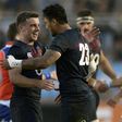 England's fly-half George Ford (L) and Denny Solomona (C) celebrate after defeating Argentina's Los Pumas during their Rugby Union test match June 10, 2017