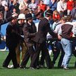 A football fan is carried from the pitch at Hillsborough stadium in Sheffield on April 15, 1989
