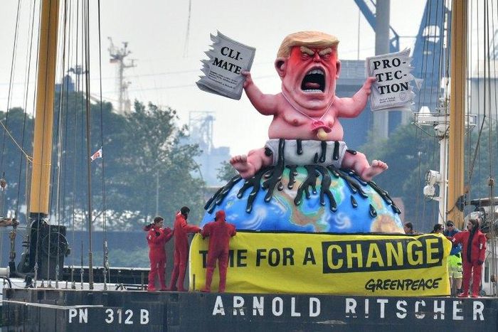 Greenpeace activists protest on a boat with a giant figure featuring US President Donald Trump in Hamburg, northern Germany where leaders of the world's top economies gather for a G20 summit