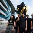 High-profile student campaigner Joshua Wong and a dozen demonstrators attached the black cloth to the giant golden bauhinia flower on Hong Kong's harbourfront in an early morning protest