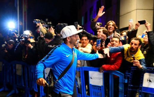 Carlos Tevez greets Boca Juniors supporters as his team arrive in Madrid for the delayed second leg of the Copa Libertadores final