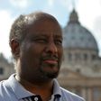 Eritrean priest Mussie Zerai poses in front of Saint Peter's basilica on October 4, 2015 in Vatican