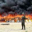 An Iranian policeman stands guard as 50 tonnes of illegal drugs are destroyed during a ceremony on June 27, 2015 in the northeast city of Mashhad