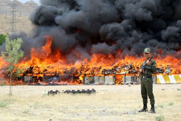 An Iranian policeman stands guard as 50 tonnes of illegal drugs are destroyed during a ceremony on June 27, 2015 in the northeast city of Mashhad