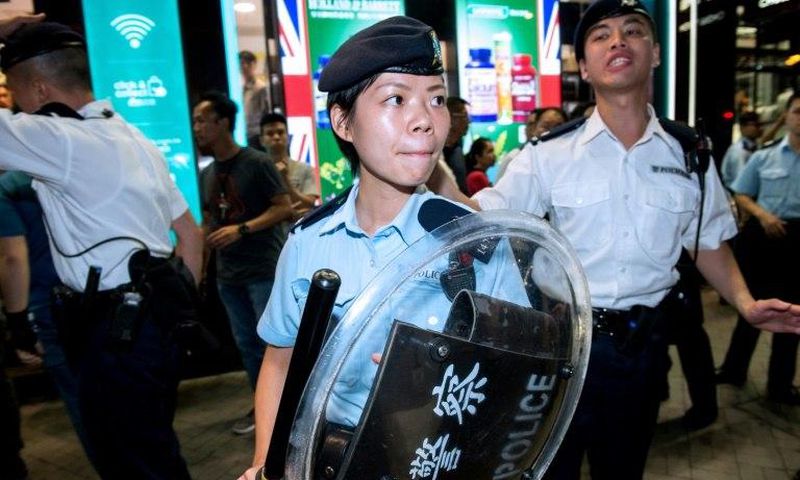 Hong Kong's police officers intervene in an altercation between Pro-China protesters and pro-independence representatives during President of China Xi Jinping's three-day visit to mark the 20th anniversary of the handover from Britain to China