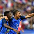 France's forward Ousmane Dembele (L) is congratulated by France's midfielder Kylian Mbappe following his goal during the international friendly football match against England at the Stade de France stadium June 13, 2017