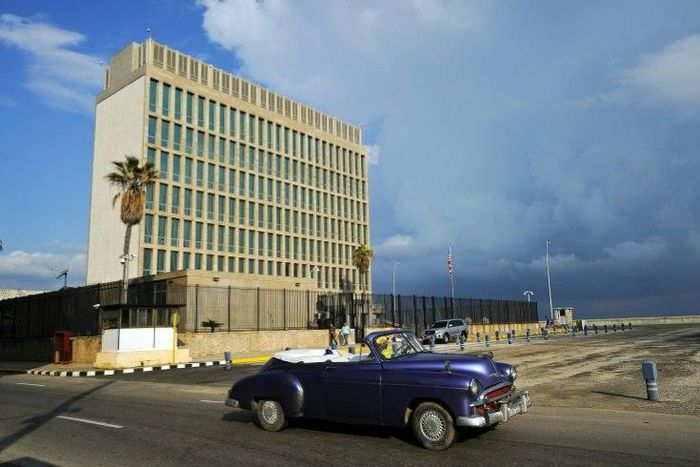 A vintage US car passing in front of the US Embassy in Havana on December 17, 2015. US and Canadian officials are investigating after reports that their dilpomats fell sick in the city after a possible "sonic attack"