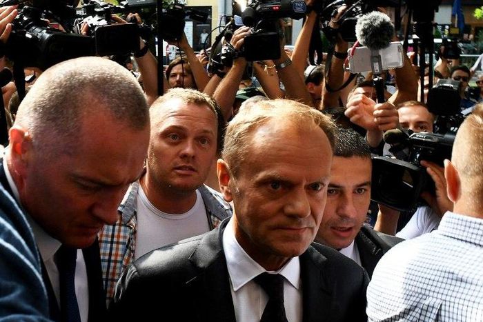 Donald Tusk (c), EU president and former Polish prime minister, arrives at the prosecutor's office to testify as a witness in the investigation of the 2010 plane crash that killed President Lech Kaczynski.