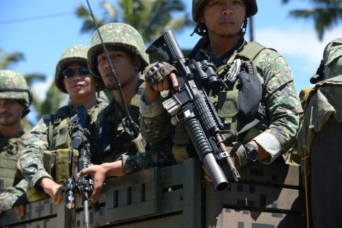 Philippine troops ride on their truck on their way to the frontline in the outskirts of Marawi on the southern island of Mindanao