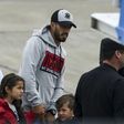 Barcelona player Luis Suarez (C) arrives with his family at the Santa Fe Province airport in Rosario, Argentina for his teammate Lionel Messi's wedding