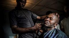Time for a trim: Ibrahim goes to a barber's shop, one of numerous businesses that have sprung up on the reserve