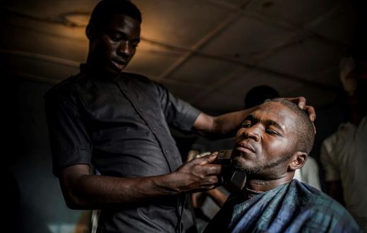 Time for a trim: Ibrahim goes to a barber's shop, one of numerous businesses that have sprung up on the reserve