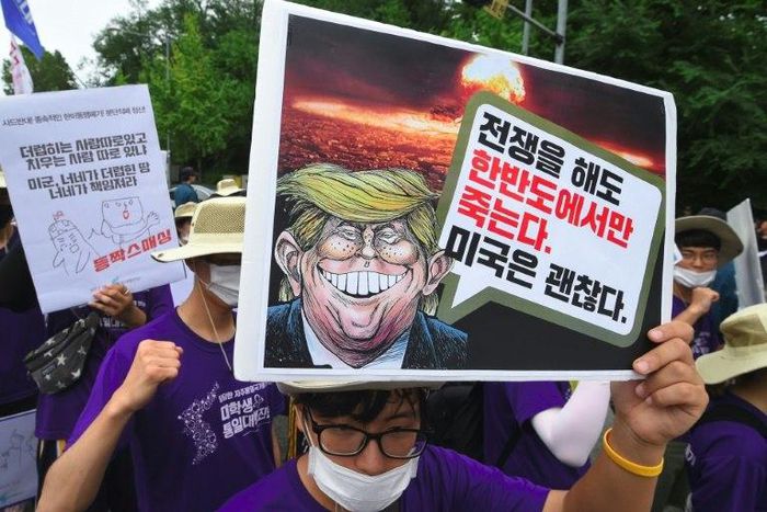 South Korean protesters hold placards at an anti-Trump rally