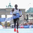 Eliud Kipchoge crosses the finish-line at Berlin's Brandenburg Gate
