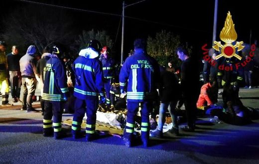 A handout picture taken and released by the Italian fire and rescue service shows emergency services staff treating victims of the stampede at a nightclub in Cornaldo