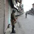 Paramilitary troops patrol the deserted streets of Srinagar as Indian Kashmir marks the first anniversary of a hugely popular rebel leader's death