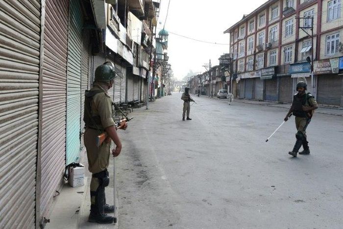 Paramilitary troops patrol the deserted streets of Srinagar as Indian Kashmir marks the first anniversary of a hugely popular rebel leader's death