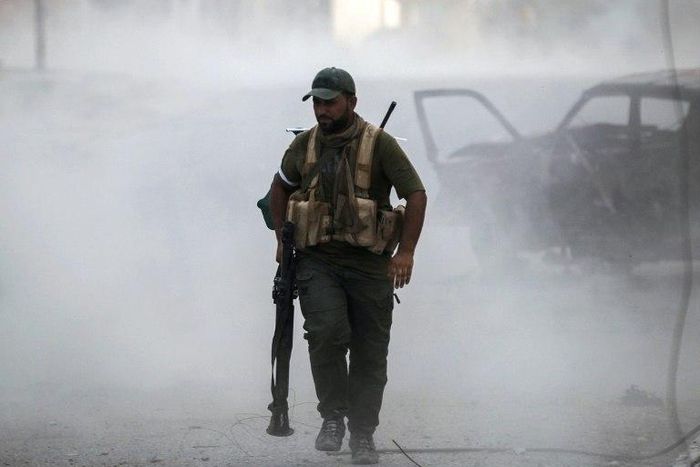 A Hashed al-Shaabi fighter carries a rocket-propelled grenade launcher in Tal Afar on August 26, 2017