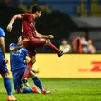 Shanghai SIPG's Oscar (L) kicks the ball at a Guangzhou R&F player during their Chinese Super League match in Guangzhou, on June 18, 2017
