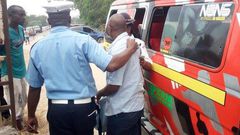 File image of a traffic police officer arresting a matatu operator