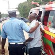 File image of a traffic police officer arresting a matatu operator