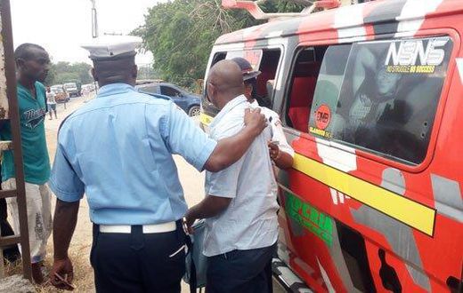 File image of a traffic police officer arresting a matatu operator