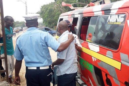 File image of a traffic police officer arresting a matatu operator