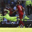 England's goalkeeper Joe Hart (L) dives but cannot reach Scotland's striker Leigh Griffiths' shot on June 10, 2017