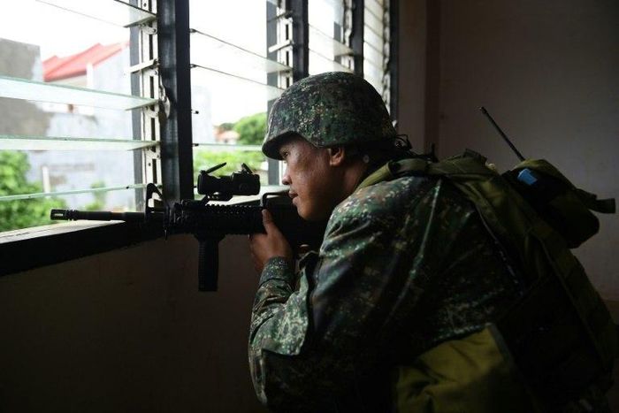 A Philippine Marine in July 2017 observed Islamic militant positions on the frontline in Marawi on the southern island of Mindanao. The US is weighing sending additional support to help the fight against IS
