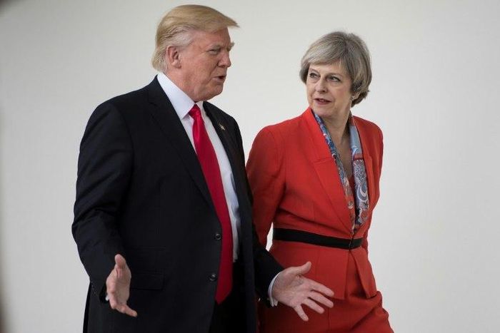US President Donald Trump and British Prime Minister Theresa May walk to a press conference at the White House on January 27, 2017