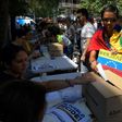 A Venezuelan resident in Barcelona casts her ballot during a symbolic plebiscite on president Maduro's project of a future constituent assembly, called by the Venezuelan opposition and held in Barcelona on July 16, 2017