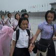 Students walk through the rain to pay their respects to late North Korean leaders Kim Il-Sung and Kim Jong-Il outside Kumsusan Palace as the country marks 'Victory Day' in Pyongyang