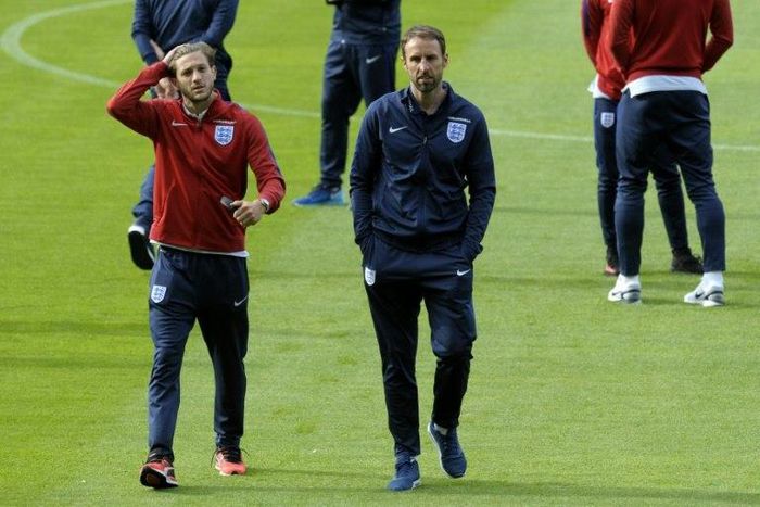 England's midfielder Adam Lallana (L) and team manager Gareth Southgate arrive at the Hampden Park stadium in Glasgow for a squad walkaround session on June 9, 2017, on the eve of their World Cup Group F qualifying match against Scotland