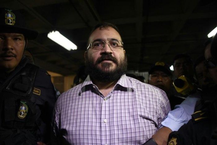 Javier Duarte, former governor of the Mexican state of Veracruz, accused of graft and involvement in organized crime, is escorted by police officers for a hearing to decide on his extradition, at the Supreme Court in Guatemala City on June 27, 2017