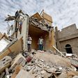 Yemenis stand in the rubble of a residential building destroyed in an air strike in the southern Faj Attan district of the capital, Sanaa, on August 25, 2017
