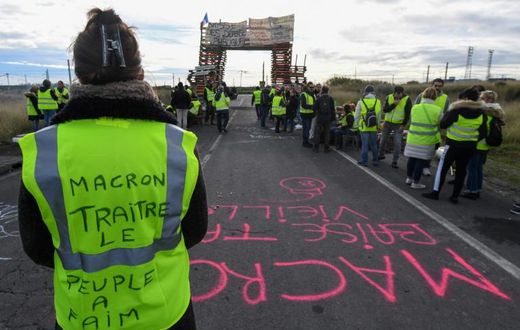 A yellow vest protester blocking a fuel depot in Frontignan, southern France, on Monday. Her vest reads "Macron traitor, the people are hungry."